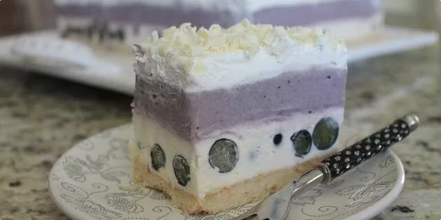 A cake with blueberries and white chocolate